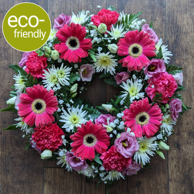 Eco-Funeral Wreath Bright - A traditional ring-shaped funeral tribute, <b>beautifully arranged in biodegradable floral foam</b>. Your tribute can be made in <b>your choice of colours</b> and <b>suitable for a lady or gentleman</b>.
