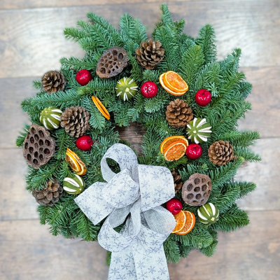 Traditional Christmas Wreath | Winter Fruits & Spruce | The Floral Box - A classic moss-backed door wreath adorned with winter fruits and a silver bow. Hand-wired using fresh Blue Spruce by Darlington's trusted florists.